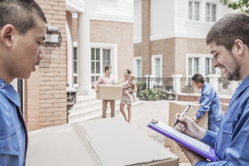Moving team handling boxes during a house removal service