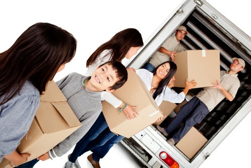 Removal team planning a safe moving job with equipment and boxes