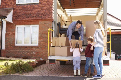 Professional movers loading boxes and furniture into a van in Richmond upon Thames