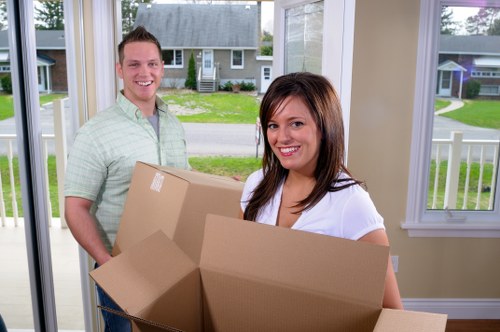 Staff member lifting a box carefully during a removals task
