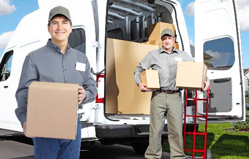 House removalists loading furniture into a moving van in Richmonduponthames