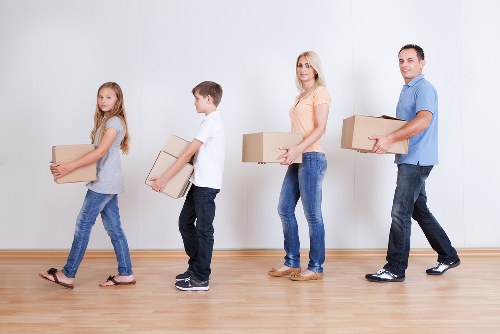 Professional removals crew working safely with packed items